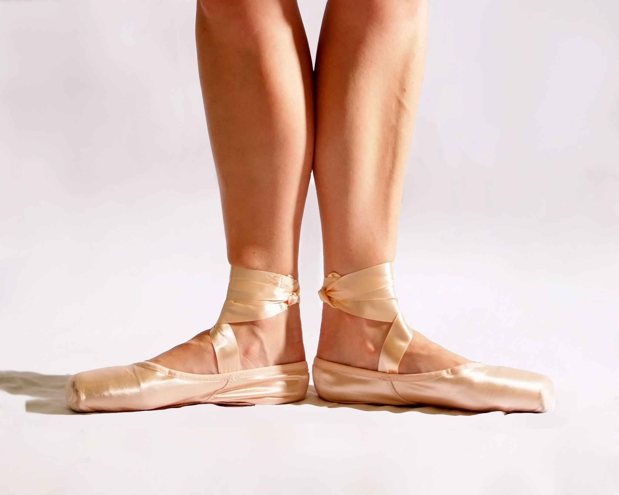 Anne Carollo's feet in first position in pointe shoes